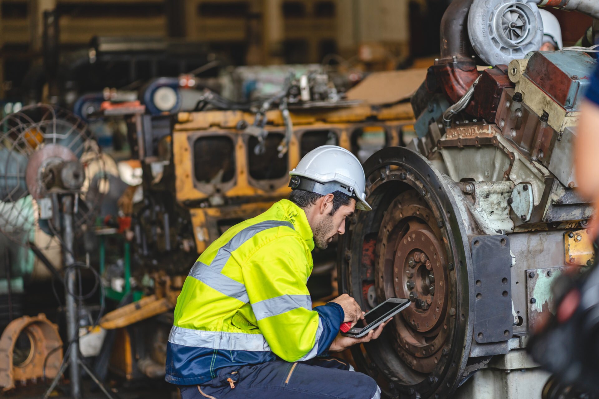 Engineer inspecting industrial production equipment in a heavy industry setting