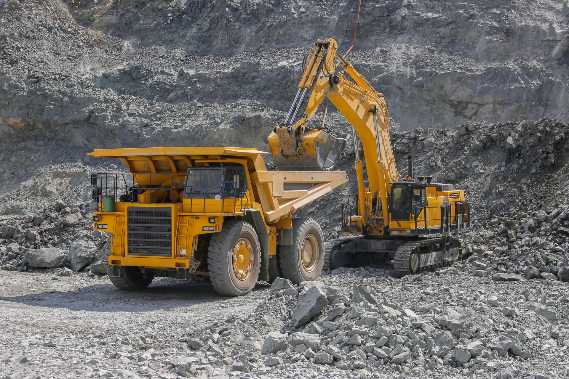 Excavator loading ore into a mining dump truck